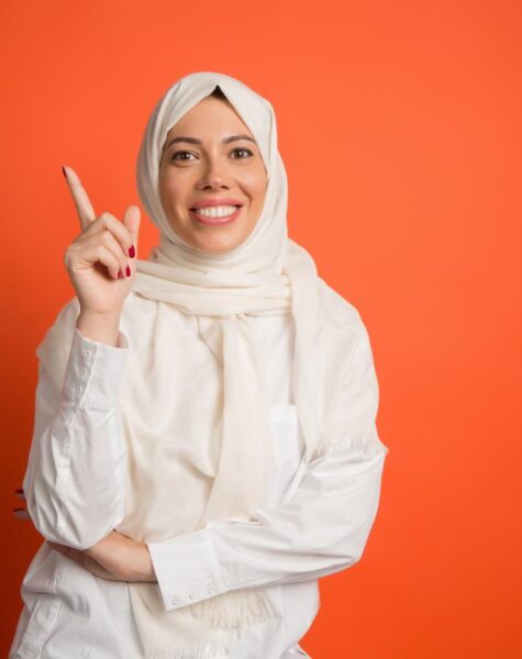 happy-arab-woman-hijab-portrait-smiling-girl-posing-red-studio-background